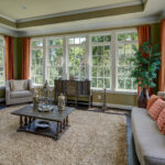 Another view of a room from a luxury home from CarrHomes in Hamilton that show off the three walls of windows.