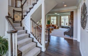 The staircase and view of the entryway showing off the interior home design from CarrHomes in Hamilton.
