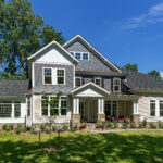 The exterior of one of CarrHomes grey, white, and tan luxury homes in Hamilton.