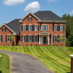 The exterior of a red brick designer home from CarrHomes in Hamilton.